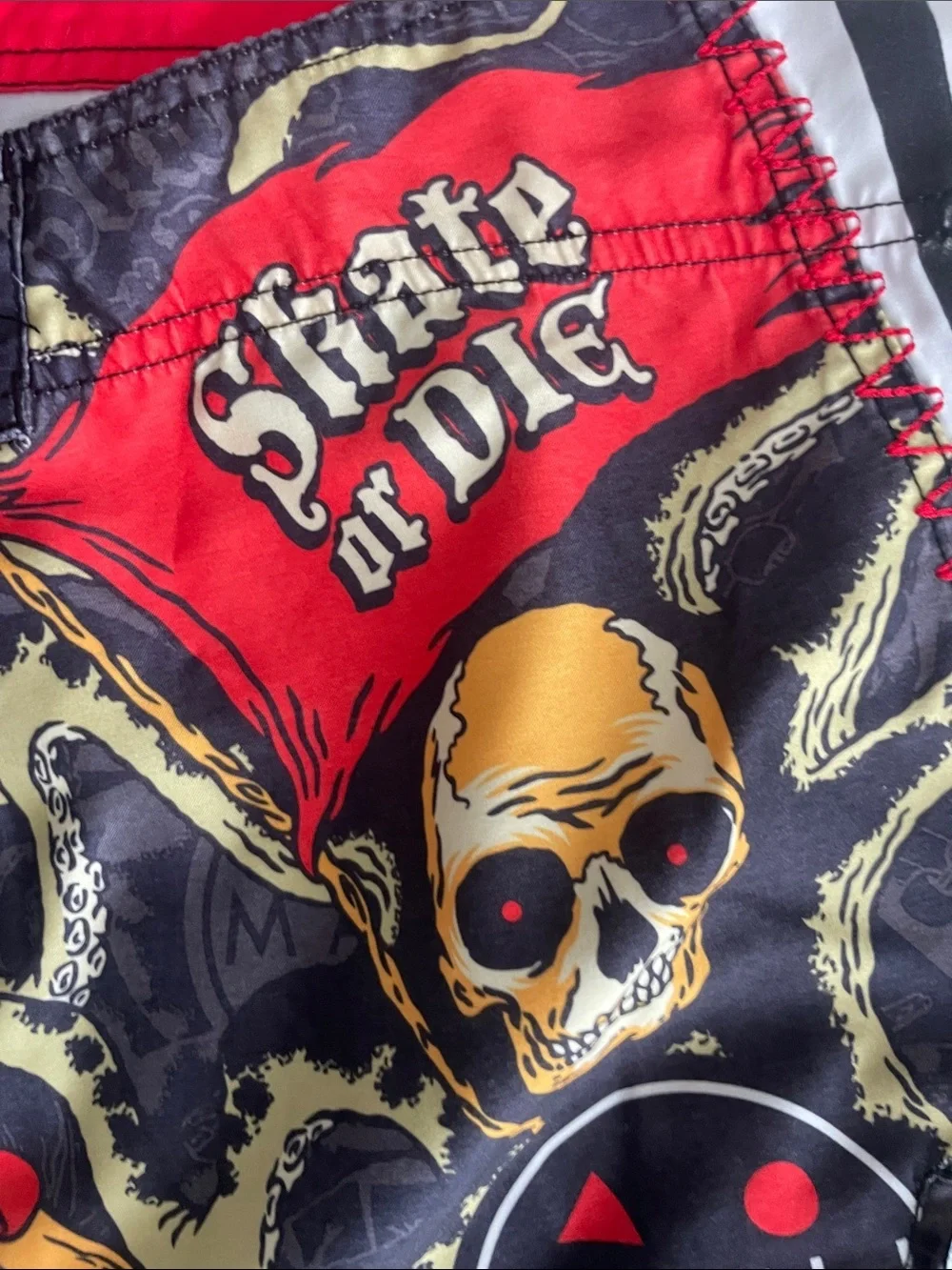 Maui and Sons Black Swim Shorts with Red & Yellow Skull Graphic
